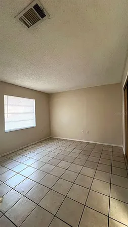a view of an empty room and a window