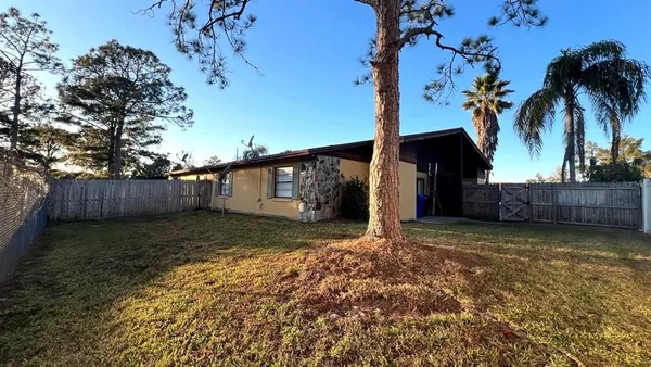 a view of a house with a yard and tree