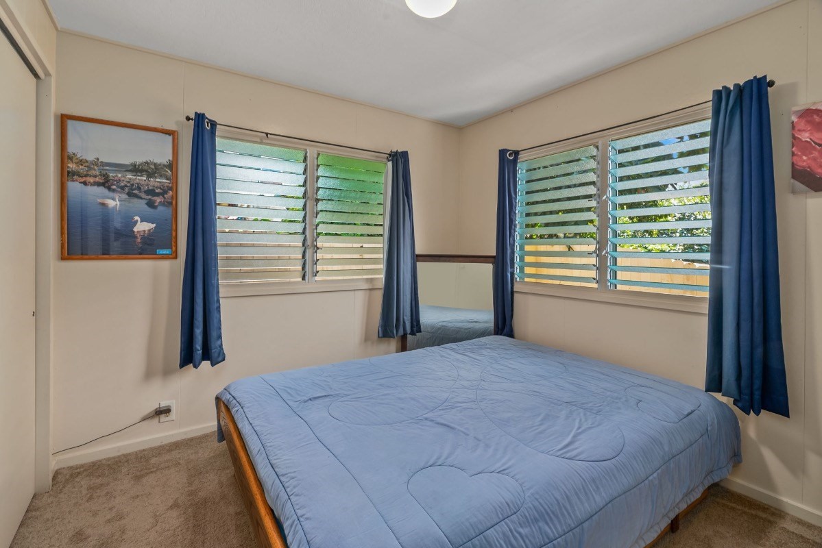 4430 Eke Road Koloa, HI 96756 - Photo 17 of 25 a bedroom with a large bed and a window