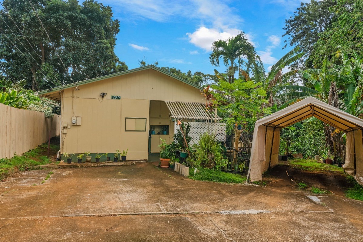 4430 Eke Road Koloa, HI 96756 - Photo 22 of 25 a view of a house with backyard and a garden
