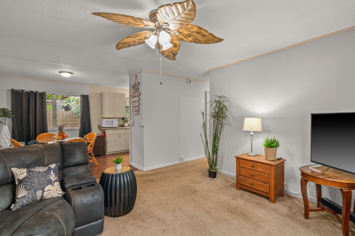 4430 Eke Road Koloa, HI 96756 - Photo 9 of 25 a living room with furniture a chandelier fan and a window