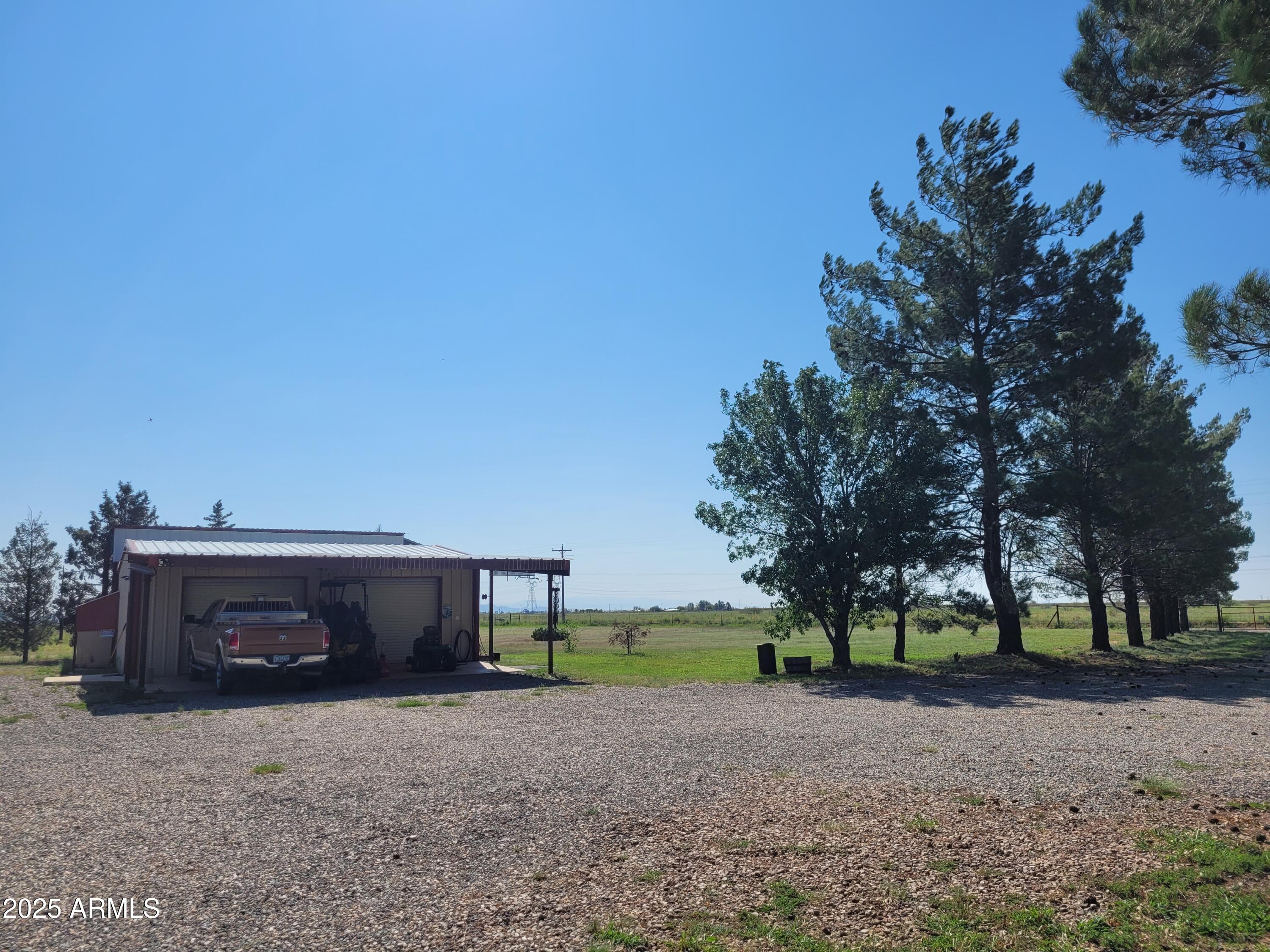8255 North Fort Grant Road Willcox, AZ 85643 - Photo 12 of 40 a front view of a house with a yard and trees