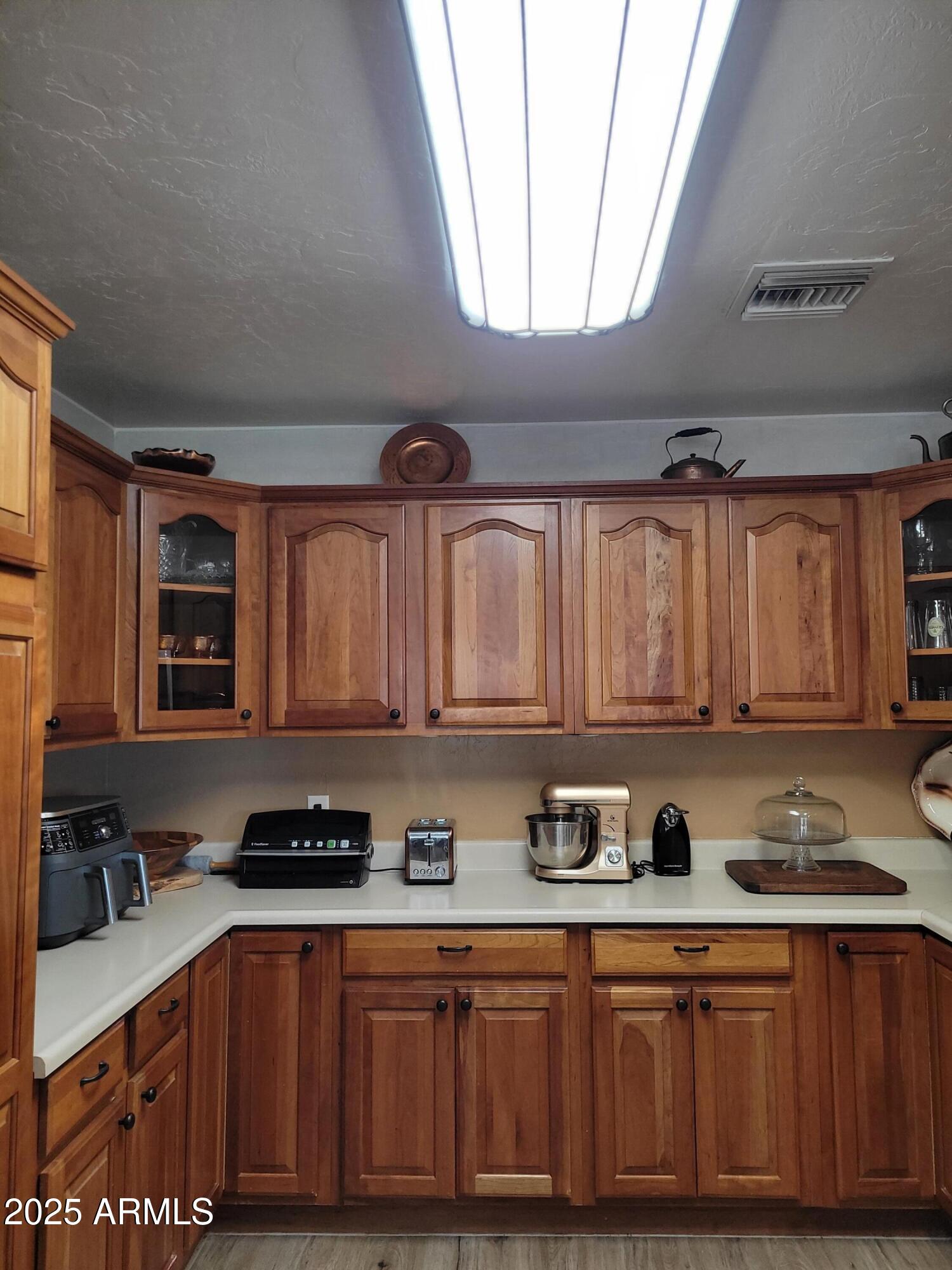8255 North Fort Grant Road Willcox, AZ 85643 - Photo 20 of 40 a kitchen with stainless steel appliances granite countertop a sink a stove cabinets and a dining table