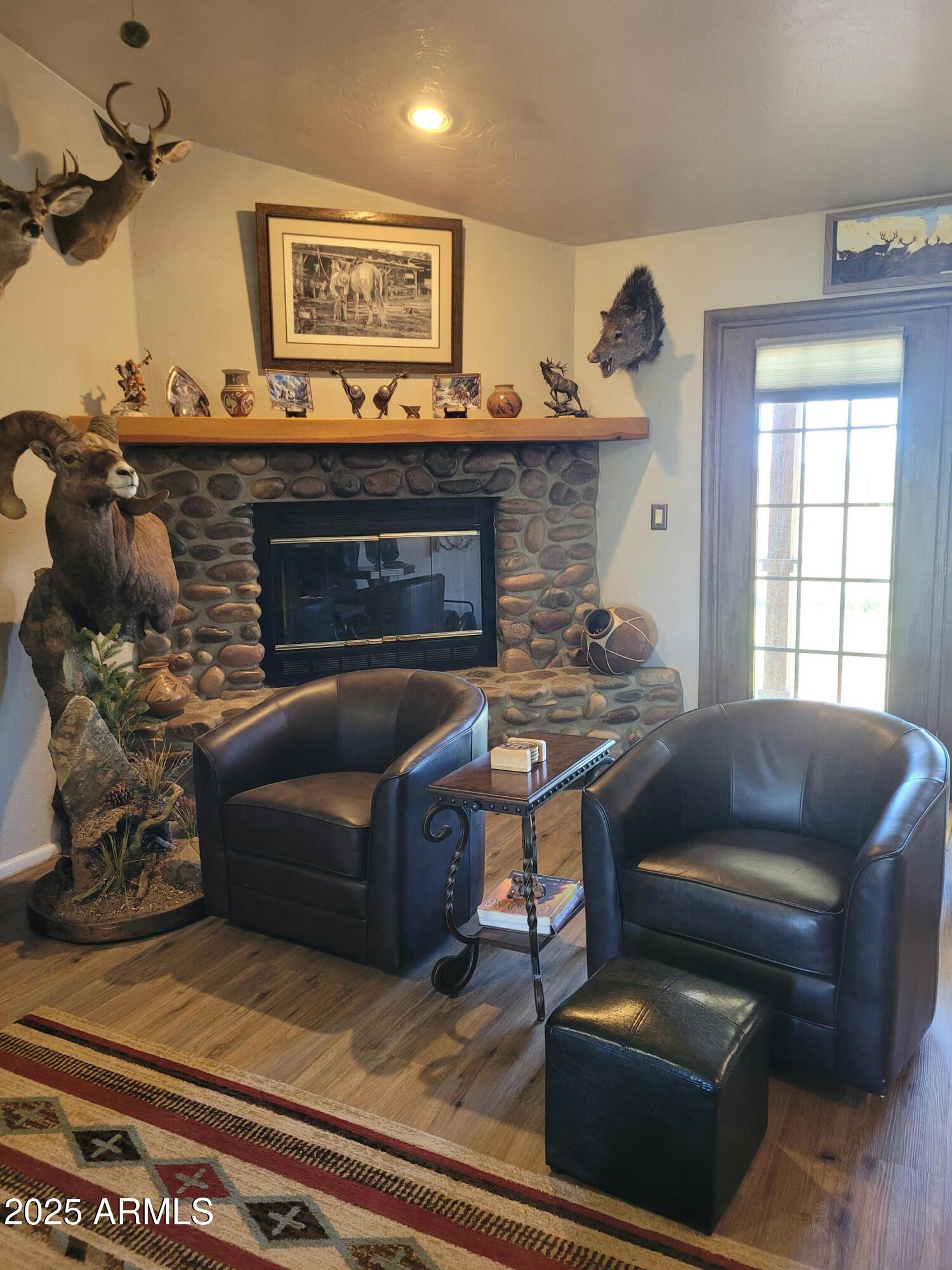 8255 North Fort Grant Road Willcox, AZ 85643 - Photo 24 of 40 a living room with furniture and a fireplace