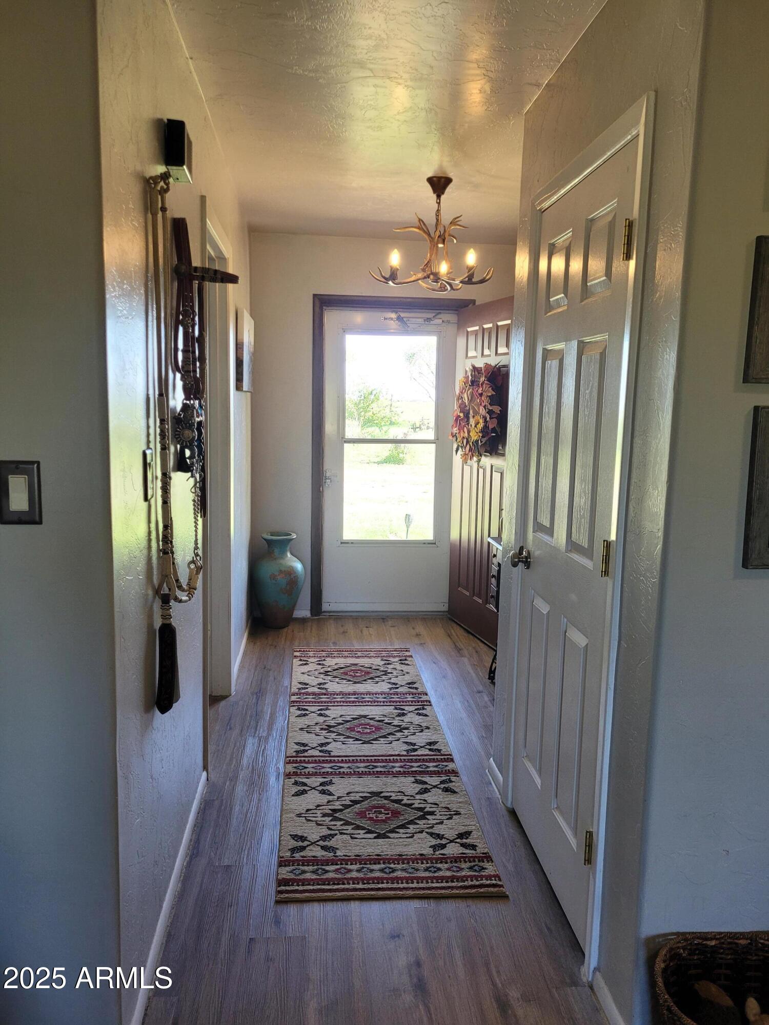 8255 North Fort Grant Road Willcox, AZ 85643 - Photo 28 of 40 a view of a hallway view with wooden floor and staircase