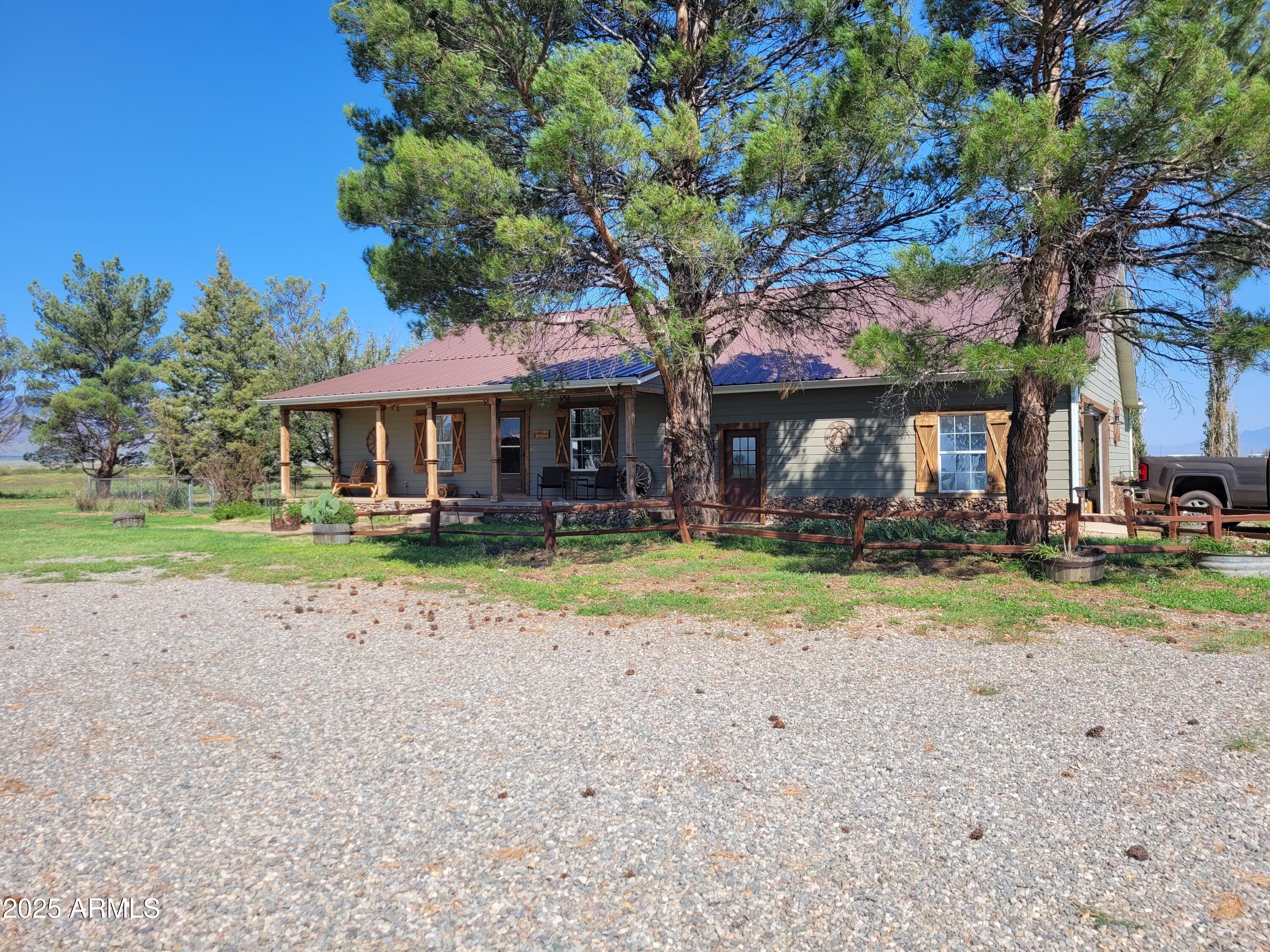 8255 North Fort Grant Road Willcox, AZ 85643 - Photo 4 of 40 a front view of a house with garden