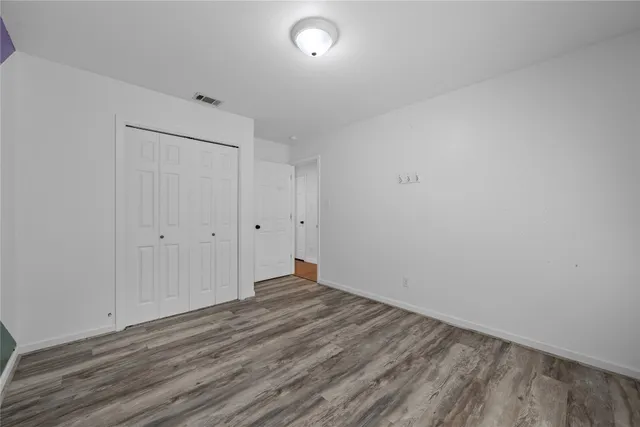 a view of room with wooden floor