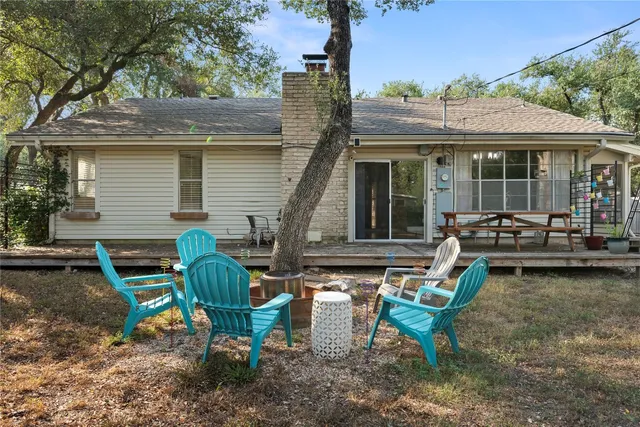 a view of a house with backyard sitting area and garden