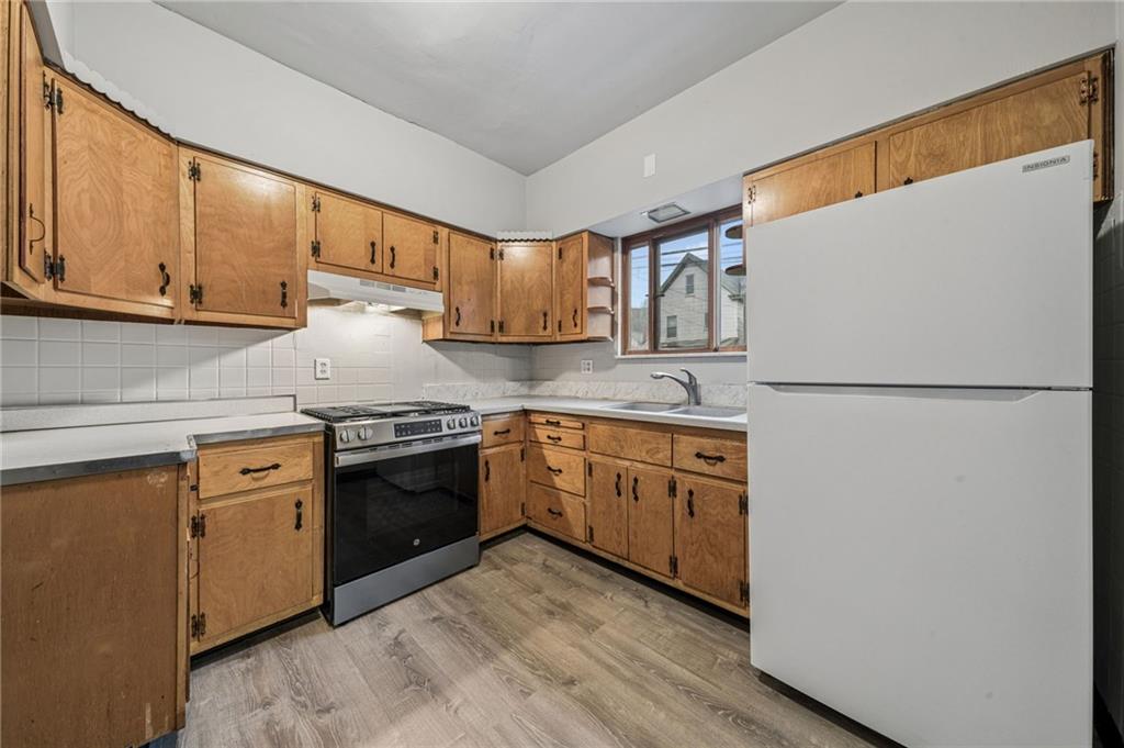 620 Broadway Avenue McKees Rocks, PA 15136 - Photo 4 of 18 a kitchen with stainless steel appliances granite countertop a refrigerator sink stove and cabinets
