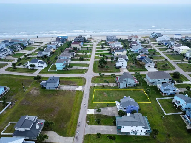 an aerial view of a pool with a yard