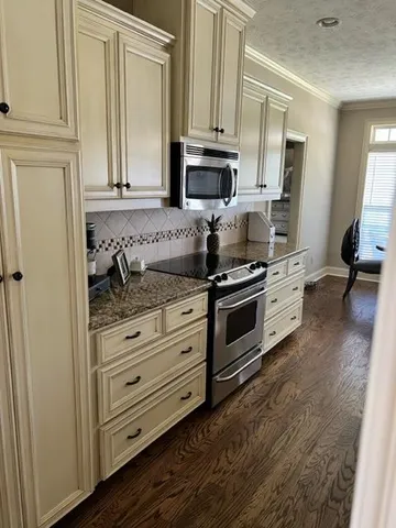 a kitchen with granite countertop cabinets and steel stainless steel appliances