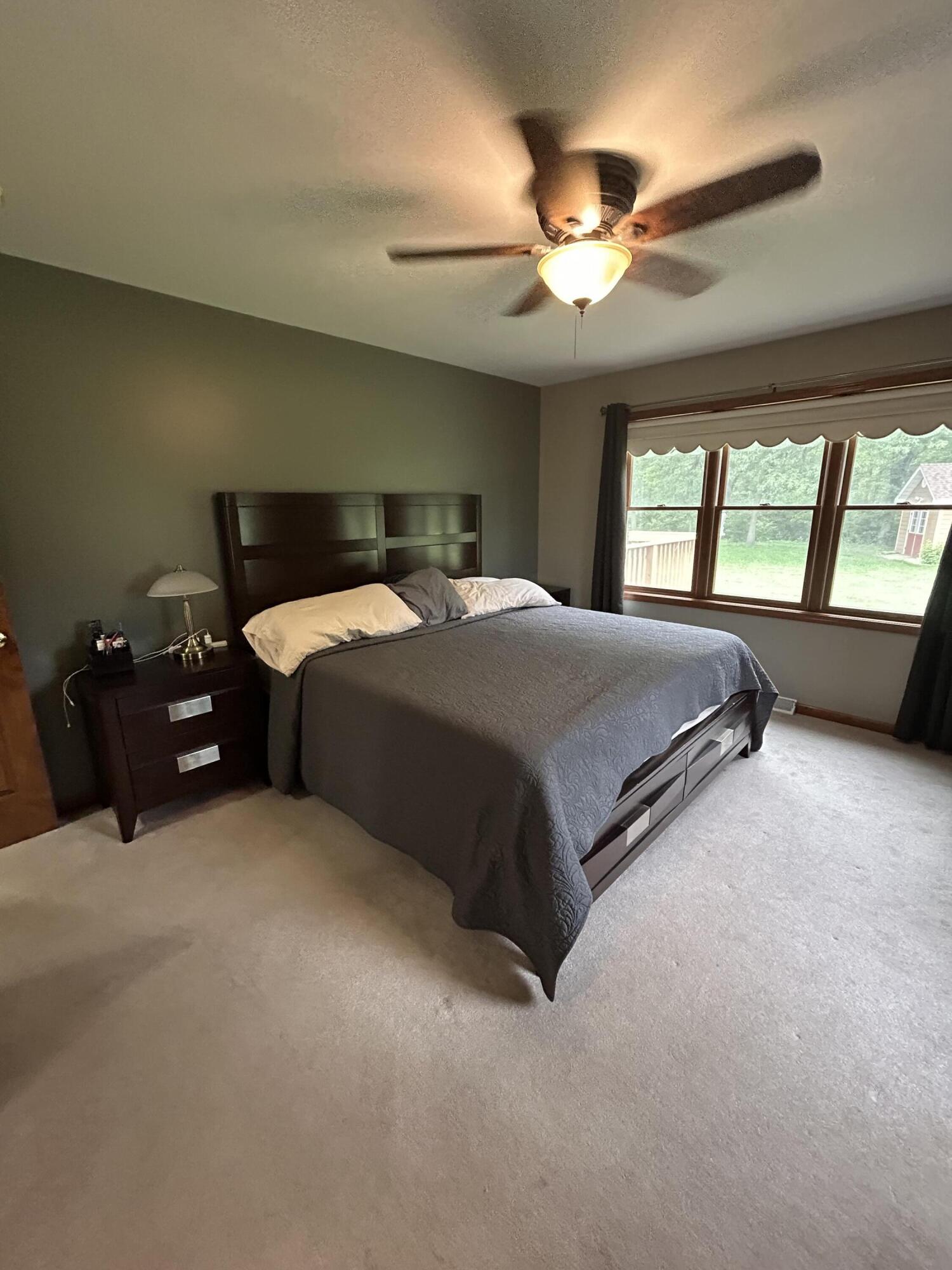 8876 North Lilac Street Demotte, IN 46310 - Photo 17 of 23 a spacious bedroom with a bed and window