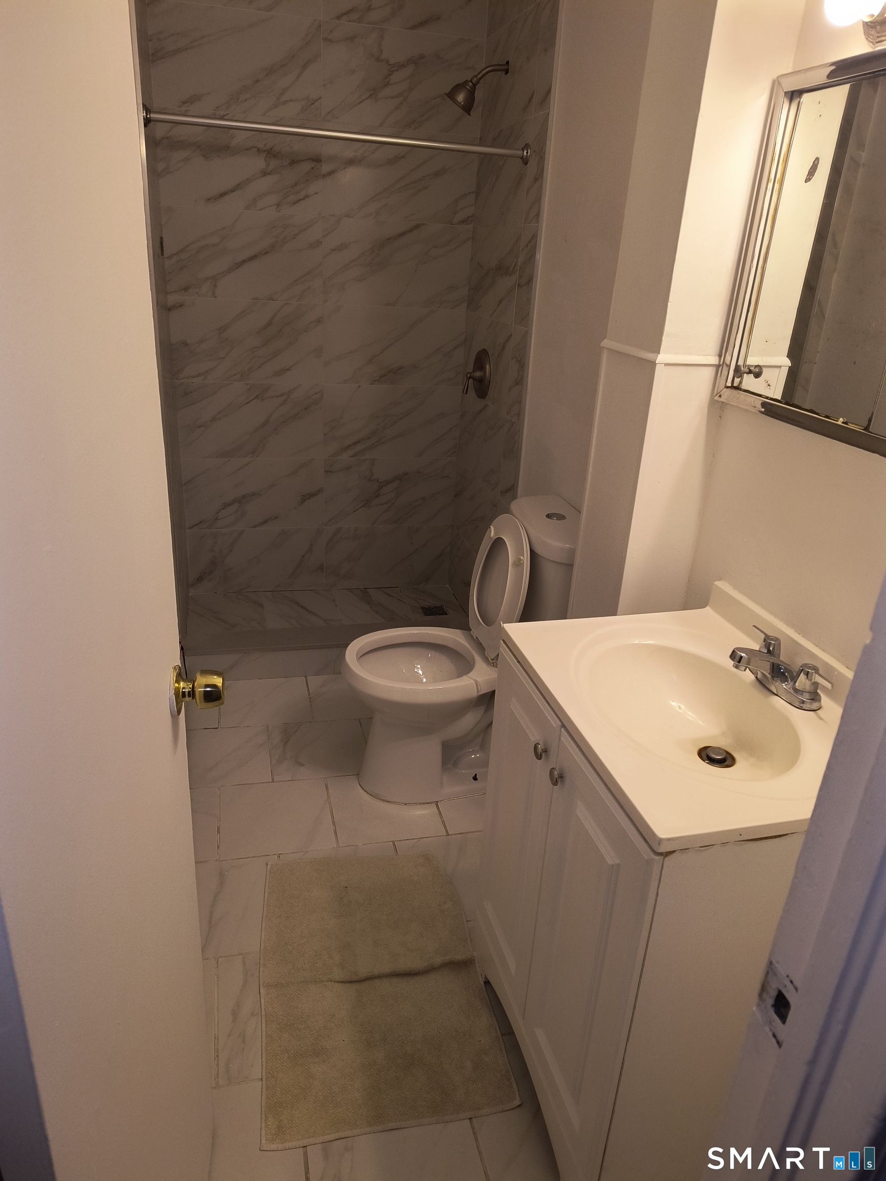 318 Center Street Bridgeport, CT 06604 - Photo 3 of 9 a bathroom with a sink toilet and shower