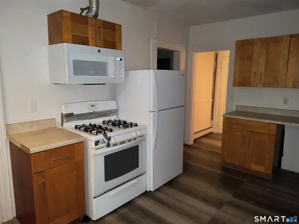 a kitchen with a stove and a refrigerator