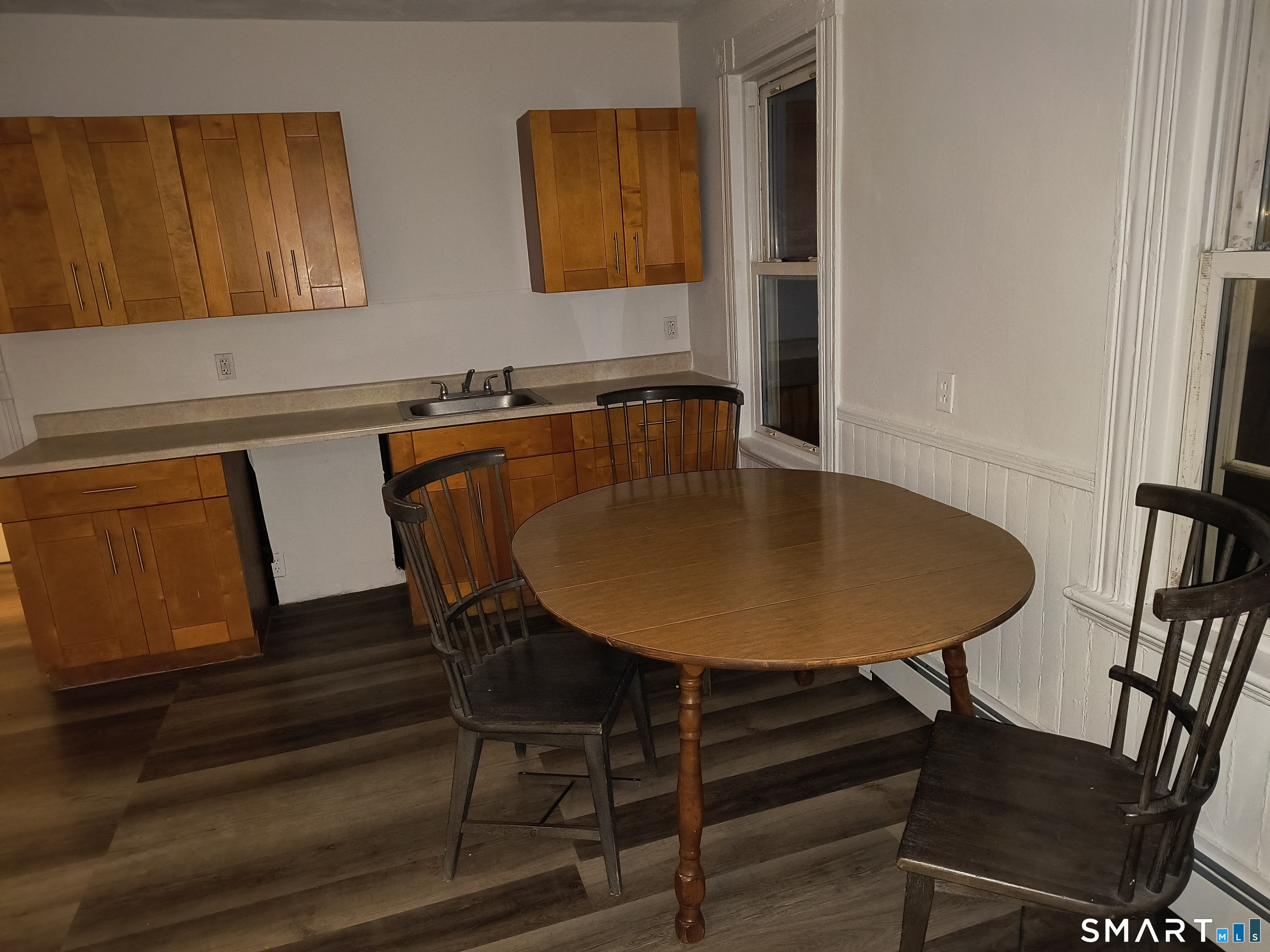 318 Center Street Bridgeport, CT 06604 - Photo 7 of 9 a view of a dining room with furniture and wooden floor