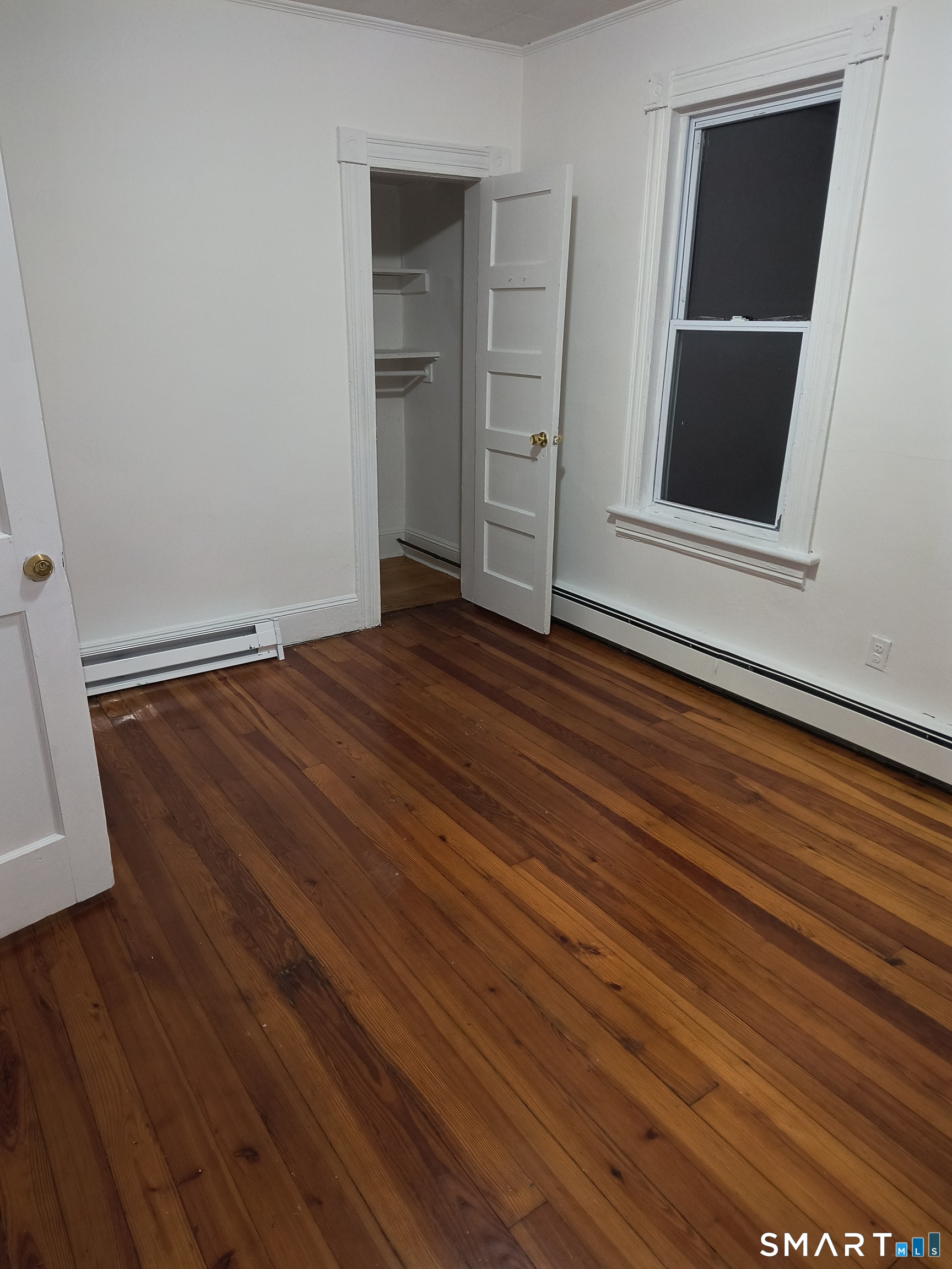 318 Center Street Bridgeport, CT 06604 - Photo 9 of 9 a view of a room with wooden floor and closet