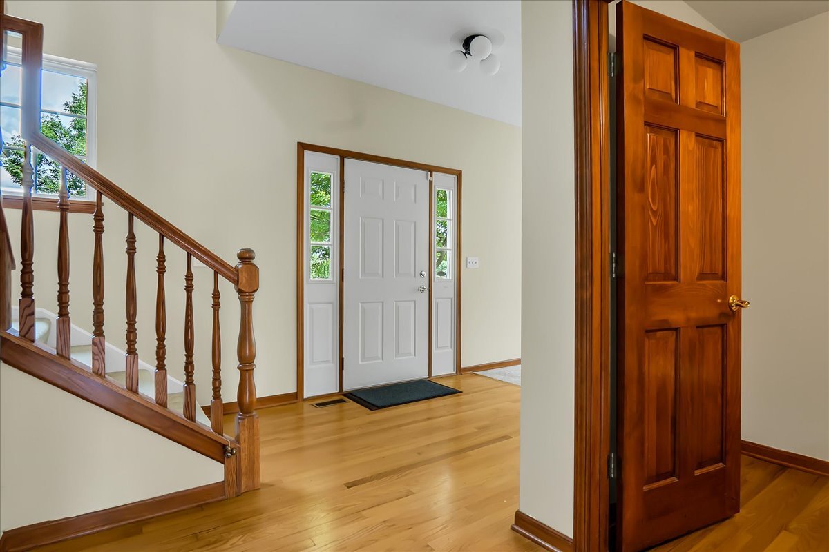 255 Hampton Road Sugar Grove, IL 60554 - Photo 2 of 28 a view of a hallway with wooden floor and staircase