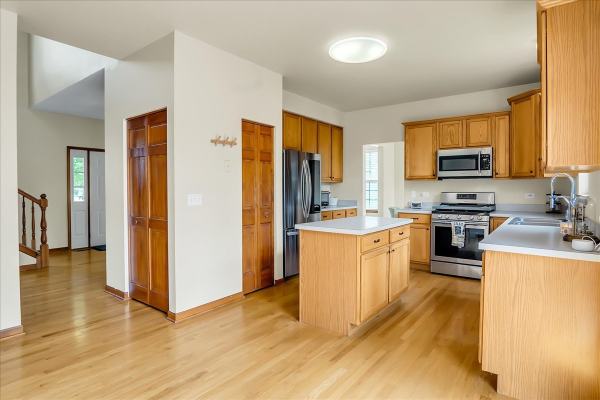 255 Hampton Road Sugar Grove, IL 60554 - Photo 7 of 28 a kitchen with stainless steel appliances granite countertop a refrigerator a stove top oven a sink and dishwasher