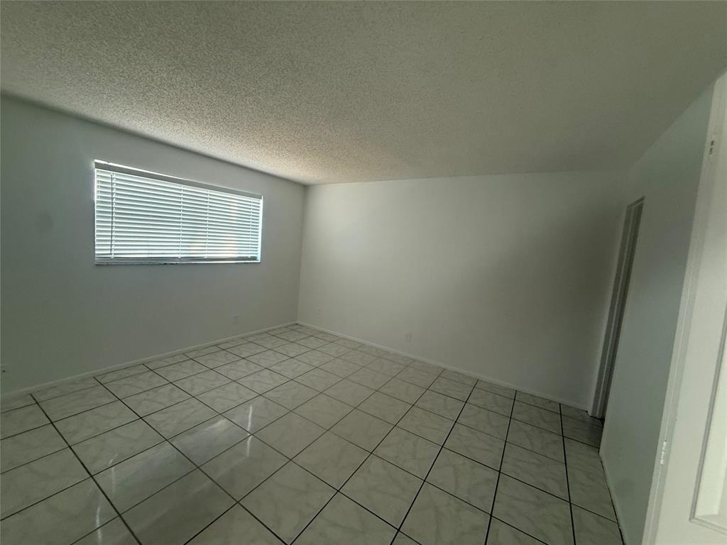 7960 North Colony Circle Tamarac, FL 33321 - Photo 2 of 11 an empty room with windows