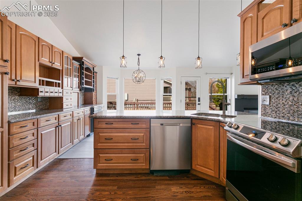 8946 Oakmont Road Peyton, CO 80831 - Photo 13 of 35 a kitchen with stainless steel appliances granite countertop a stove and a sink