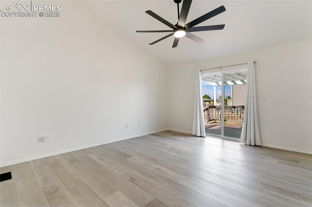 8946 Oakmont Road Peyton, CO 80831 - Photo 16 of 35 an empty room with wooden floor and windows