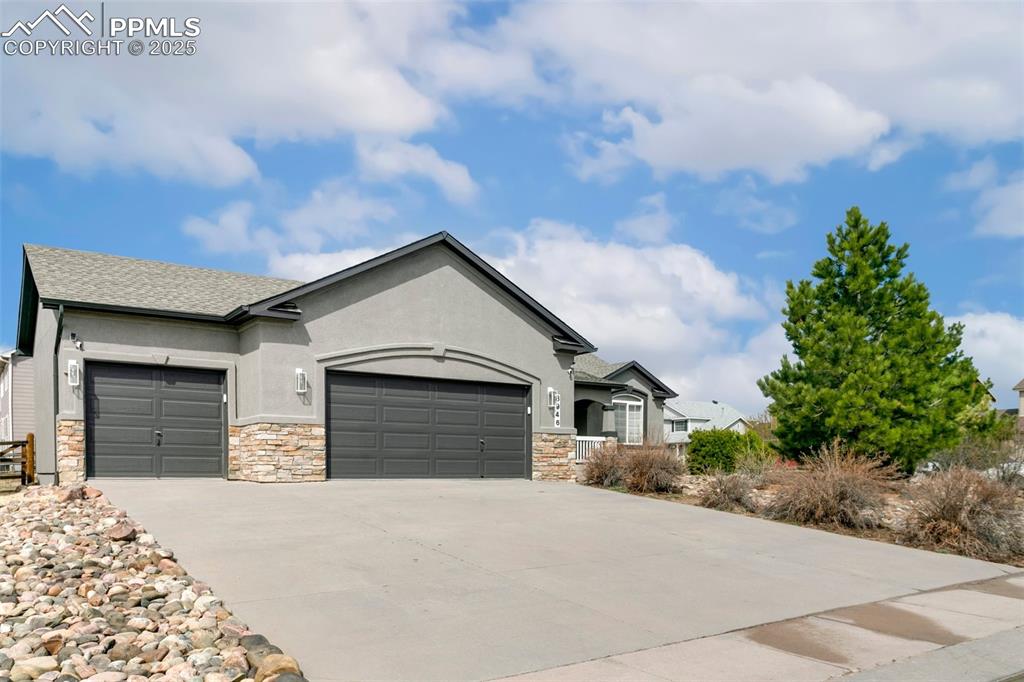 8946 Oakmont Road Peyton, CO 80831 - Photo 2 of 35 a front view of a house with a yard and garage