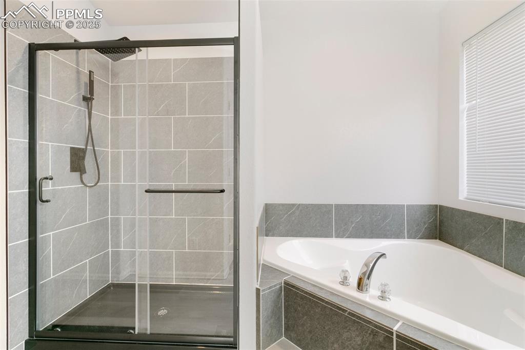 8946 Oakmont Road Peyton, CO 80831 - Photo 21 of 35 a bathroom with a bathtub and a shower