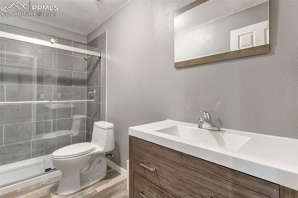 8946 Oakmont Road Peyton, CO 80831 - Photo 27 of 35 a bathroom with a sink a toilet and a mirror