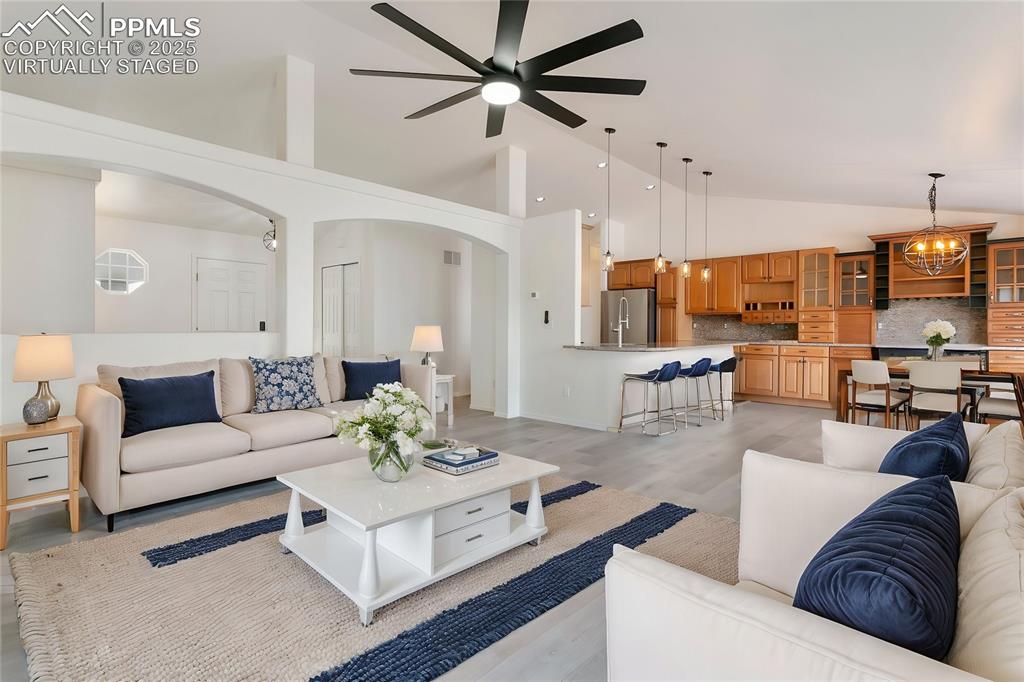 8946 Oakmont Road Peyton, CO 80831 - Photo 5 of 35 a living room with furniture kitchen view and a chandelier