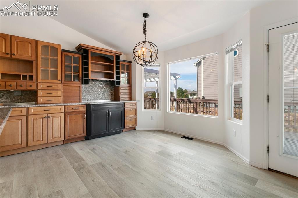 8946 Oakmont Road Peyton, CO 80831 - Photo 10 of 35 a view of a kitchen with stainless steel appliances granite countertop a stove a sink and a large window