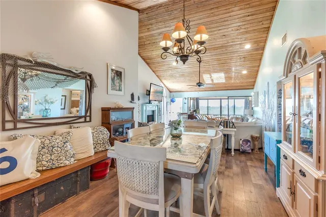 a view of a dining room with furniture wooden floor and chandelier