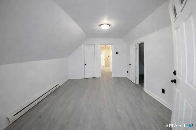 a view of a room with wooden floor