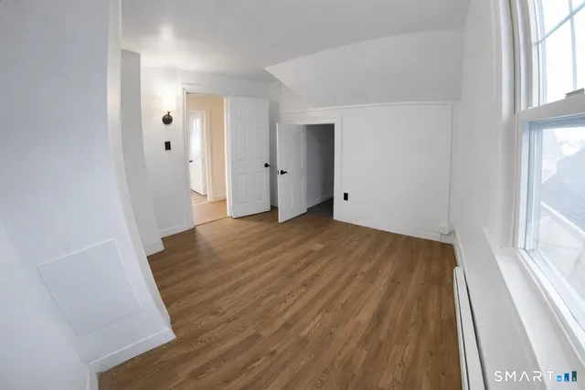wooden floor in an empty room with a window