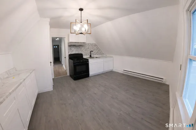 a room with fireplace and cabinets