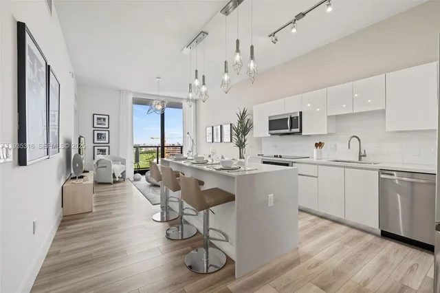 a living room with furniture a flat screen tv and floor to ceiling window