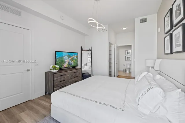 a bedroom with furniture and a large window