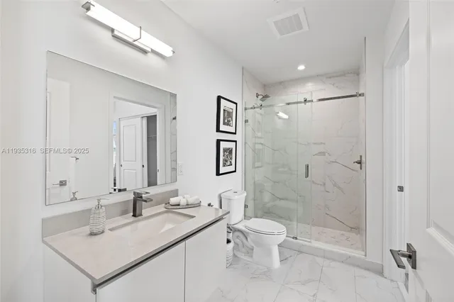 a living room with furniture and large windows