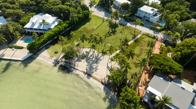 an aerial view of residential house with swimming pool and lawn chairs