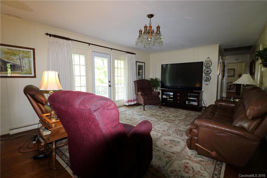 503 Roy Eaker Road Cherryville, NC 28021 - Photo 3 of 17 a living room with furniture a flat screen tv and a chandelier