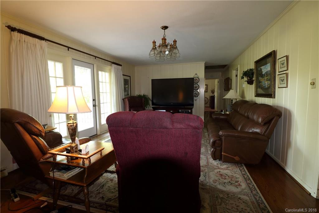 503 Roy Eaker Road Cherryville, NC 28021 - Photo 4 of 17 a living room with furniture a flat screen tv and large windows