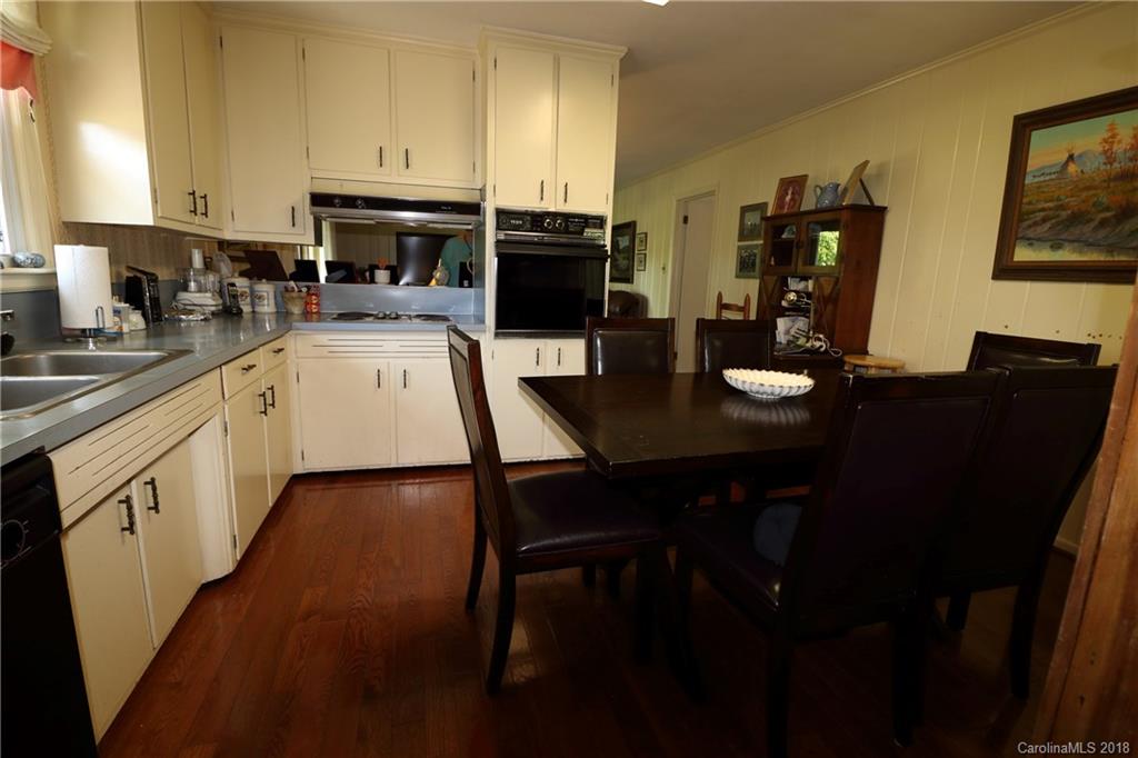503 Roy Eaker Road Cherryville, NC 28021 - Photo 7 of 17 a kitchen with a sink chairs and cabinets