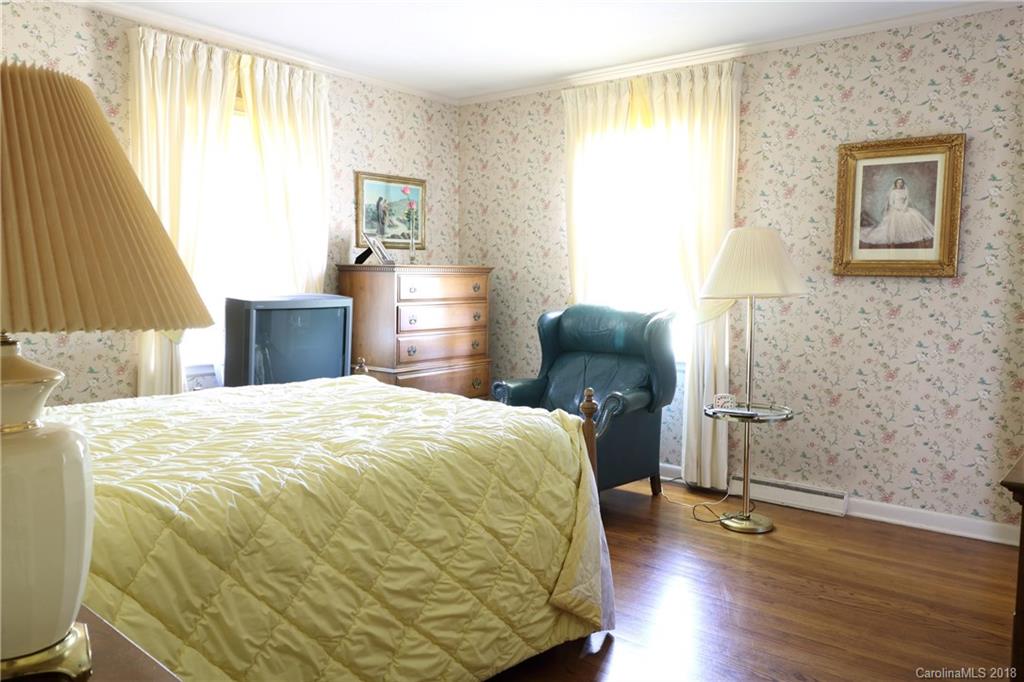 503 Roy Eaker Road Cherryville, NC 28021 - Photo 9 of 17 a bedroom with a bed and wooden floor