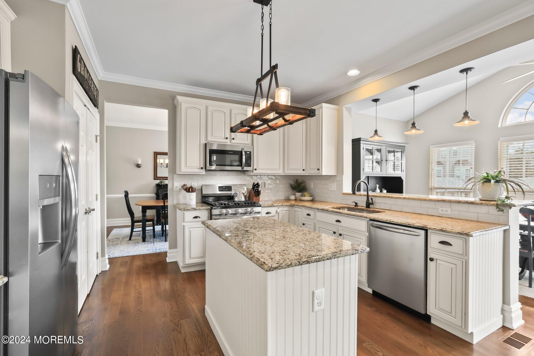 24 Firestone Drive Howell, NJ 07731 - Photo 14 of 70 a kitchen with stainless steel appliances granite countertop sink stove top oven and refrigerator