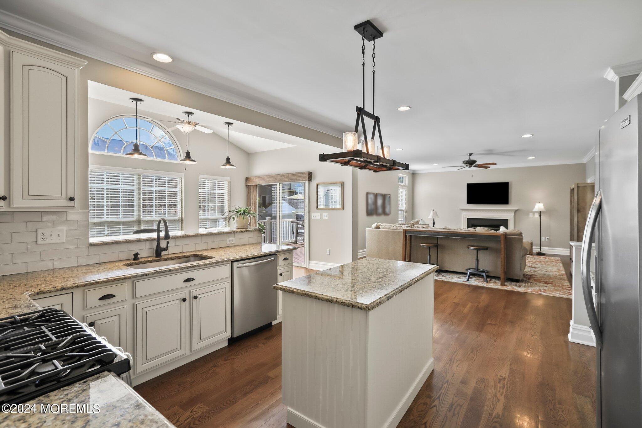 24 Firestone Drive Howell, NJ 07731 - Photo 16 of 70 a kitchen with stainless steel appliances kitchen island granite countertop a sink stove and refrigerator