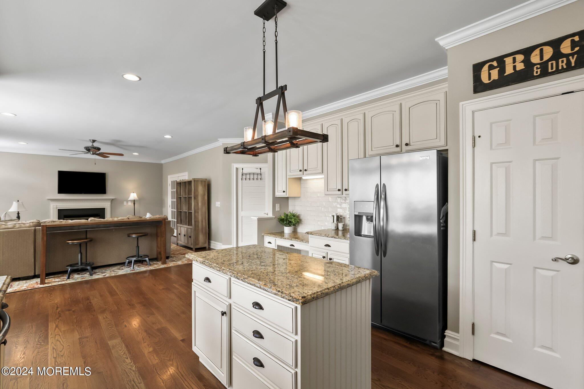 24 Firestone Drive Howell, NJ 07731 - Photo 17 of 70 a kitchen with stainless steel appliances granite countertop a refrigerator a stove and a sink with wooden floor