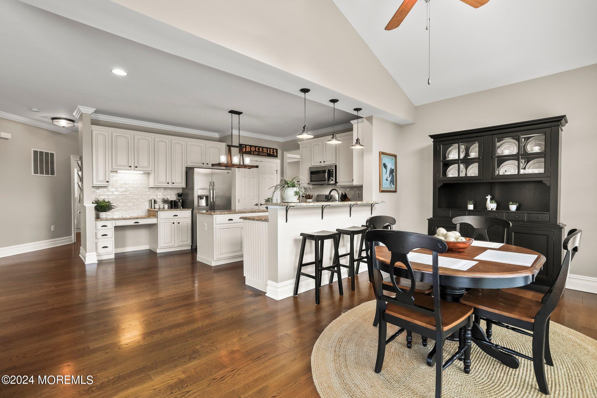 24 Firestone Drive Howell, NJ 07731 - Photo 20 of 70 a kitchen with stainless steel appliances kitchen island granite countertop a dining table chairs and white cabinets