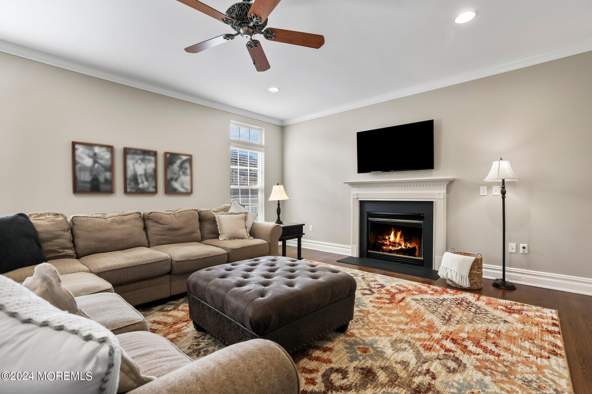 24 Firestone Drive Howell, NJ 07731 - Photo 23 of 70 a living room with furniture a flat screen tv and a fireplace