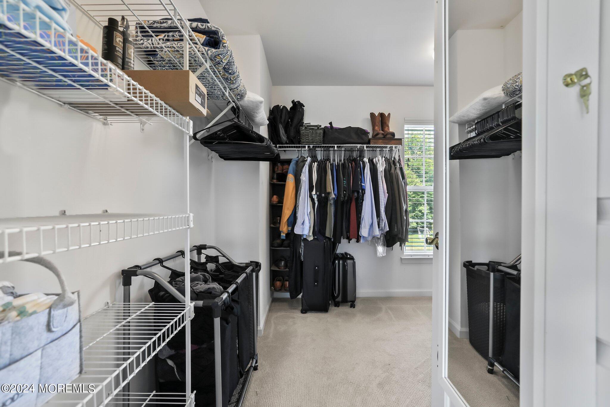 24 Firestone Drive Howell, NJ 07731 - Photo 41 of 70 a view of walk in closet with clothes and shoes