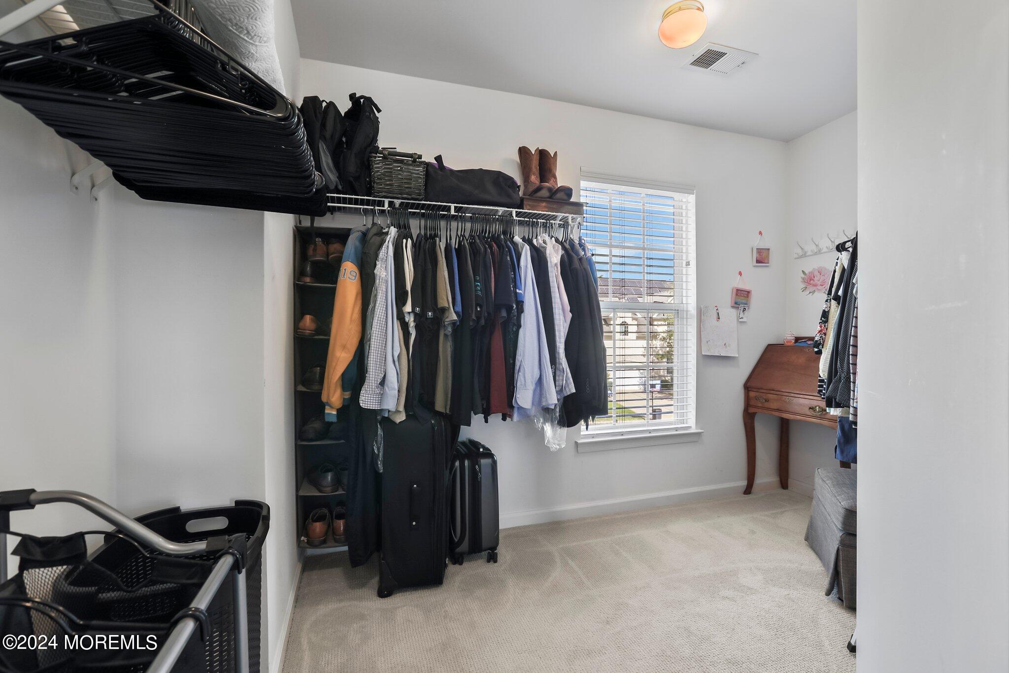 24 Firestone Drive Howell, NJ 07731 - Photo 42 of 70 a view of walk in closet with clothes and shoes