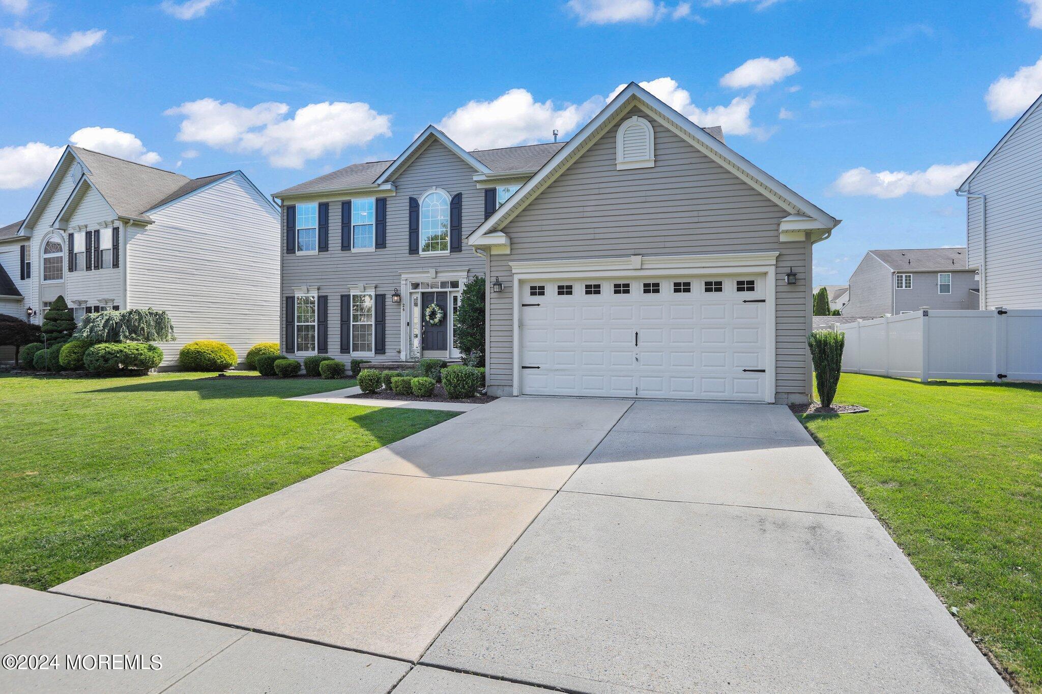 24 Firestone Drive Howell, NJ 07731 - Photo 6 of 70 a front view of a house with a yard and garage